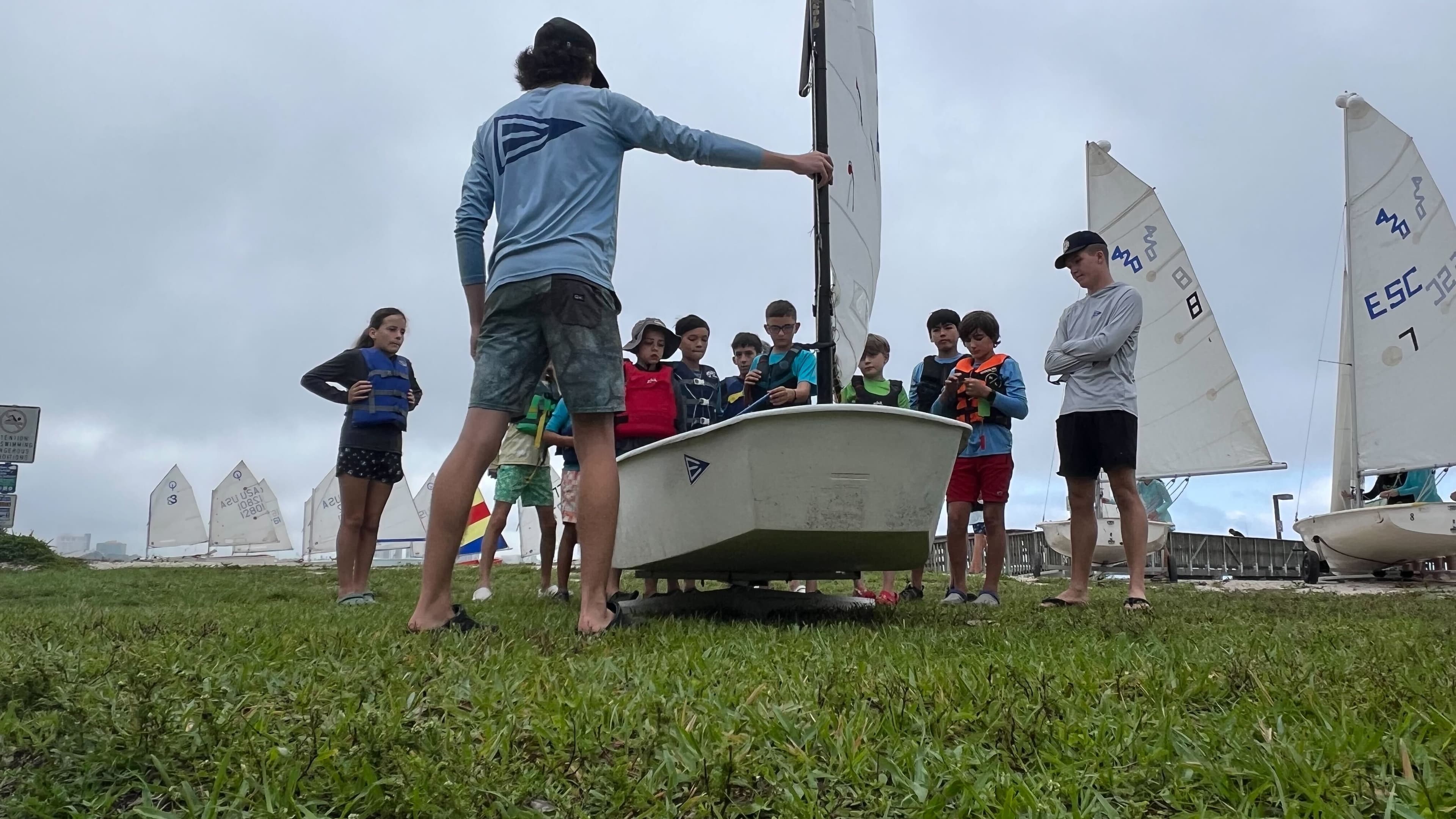 Instructor gathered with kids in a circle at Edison Sailing Center